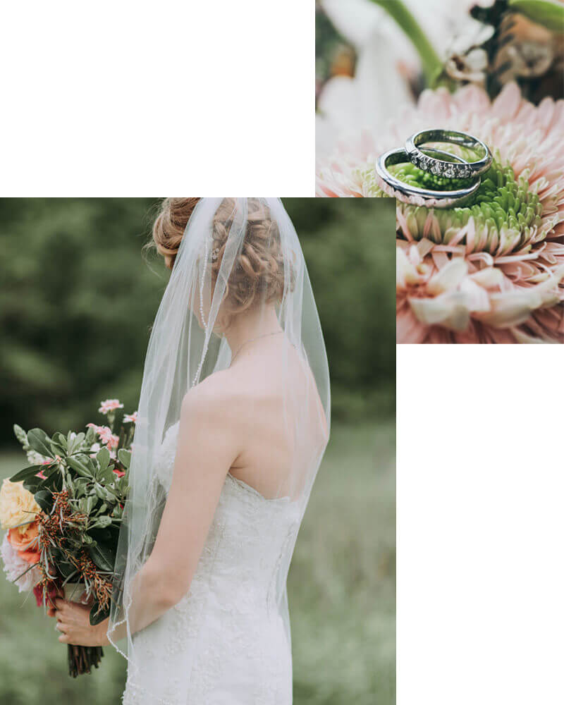 A bride in a strapless white gown and veil holds a bouquet of flowers outdoors; above, two wedding rings rest on a pink flower.