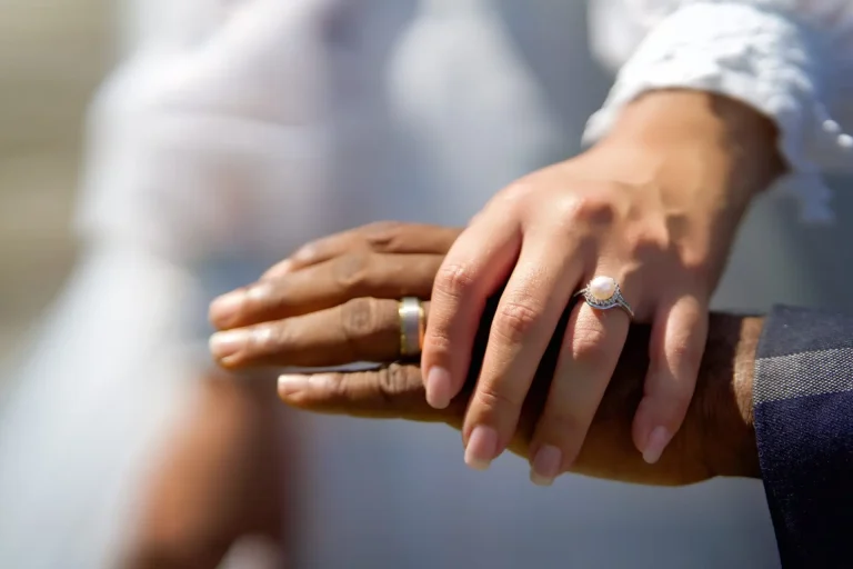 Close-up of the couple's hands and wedding rings